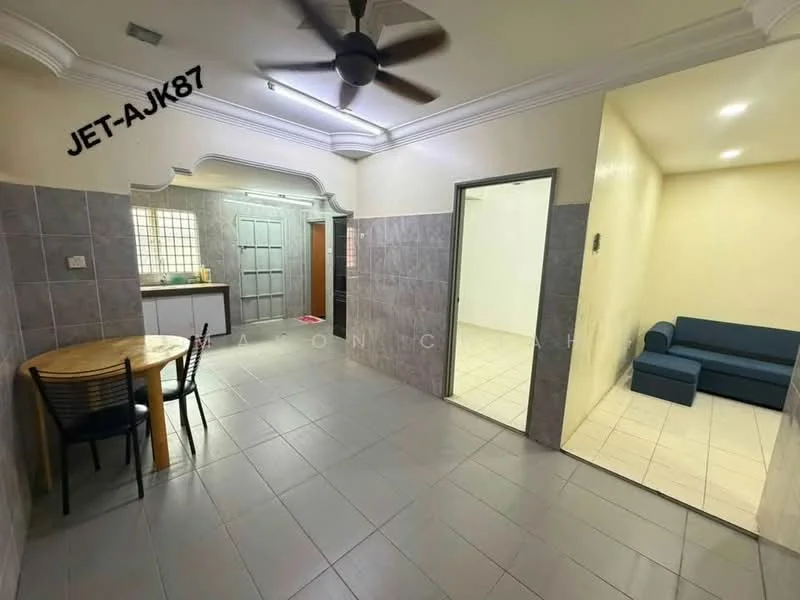 Living features: grey tiled flooring, white painted walls, 5-blade ceiling fan with light, round dining table, 4 dining chairs, sofa in blue fabric, wall-mounted light switch, doorway leading to another room; style: modern. Kitchen features: grey tiled flooring, white painted walls, wooden cabinetry, sink, window with grid pattern, countertop, door leading to outside; style: modern. Room features: grey tiled flooring, white painted walls, doorway leading to living area.