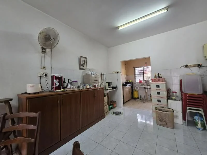 Kitchen features: white painted walls, glossy white tile flooring, ceiling-mounted fluorescent lighting, wooden cabinetry, stainless-steel sink, chrome faucet, built-in gas stove, microwave, refrigerator, kitchen counter, open shelving, plastic stackable chairs, wall-mounted fan.