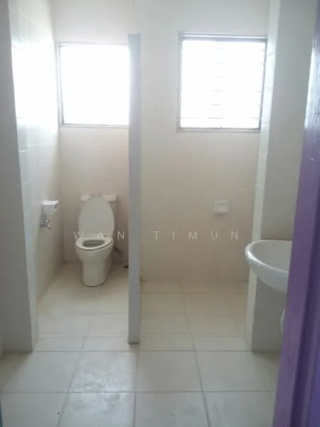 Bathroom features: white tiled walls, white ceramic floor tiles, one-piece toilet, sink with pedestal, window with horizontal slats, light fixture, toilet paper holder, soap dish.