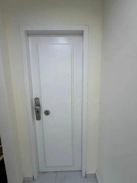 Room features: white painted walls, white door, metal door handle, tile flooring.