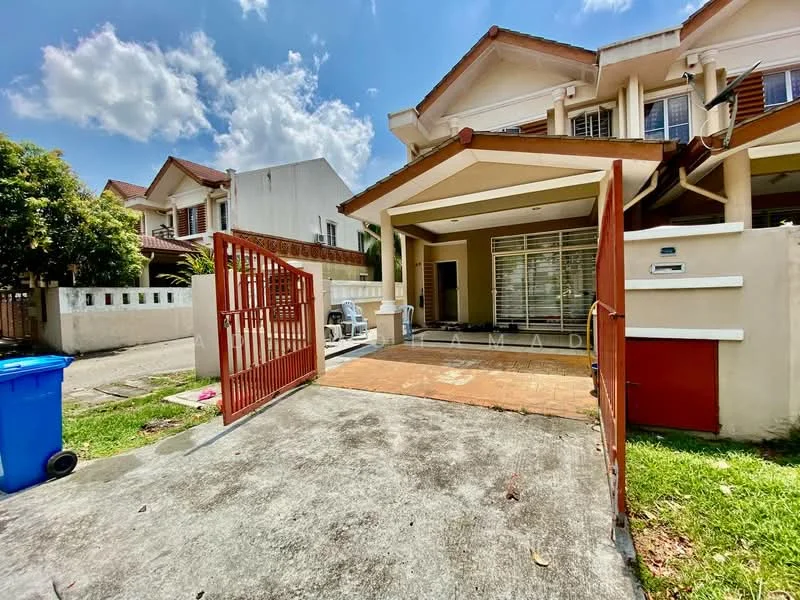 Exterior type: linked terrace house; features: red metal gate, paved driveway, manicured lawn, white painted facade, terracotta roof tiles, single-storey car porch, outdoor seating area, surrounded by greenery, clear blue sky, clouds in the sky; style: modern.