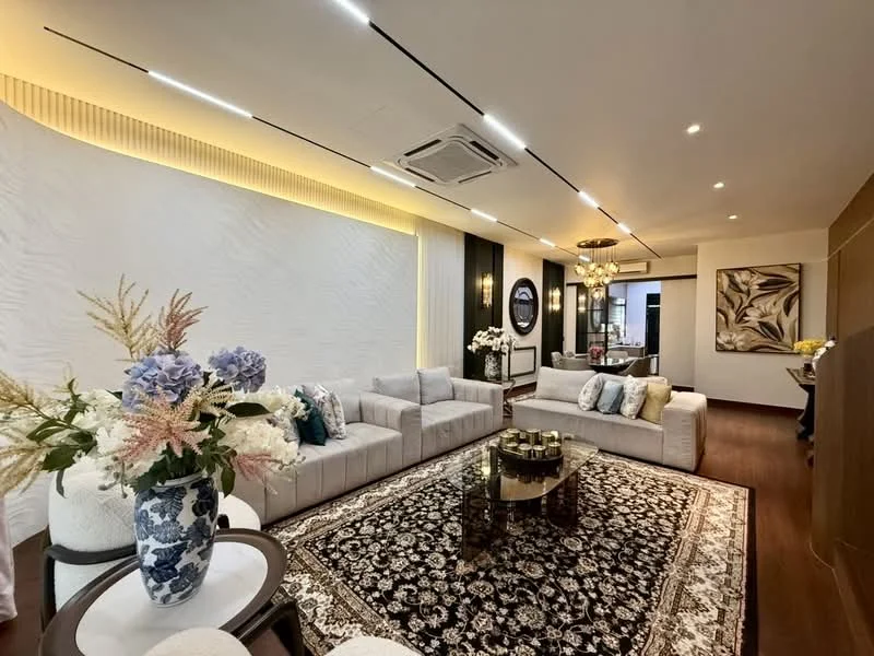 Living features: 3-seater fabric sofa in light grey, 2-seater fabric sofa in light grey, round coffee table with glass top, area rug with intricate pattern, wall-mounted TV, decorative wall with textured white finish, recessed LED downlights, chandelier with multiple bulbs, decorative mirror, floral arrangement in blue and white vase, wooden flooring, wall art with abstract design; style: modern.