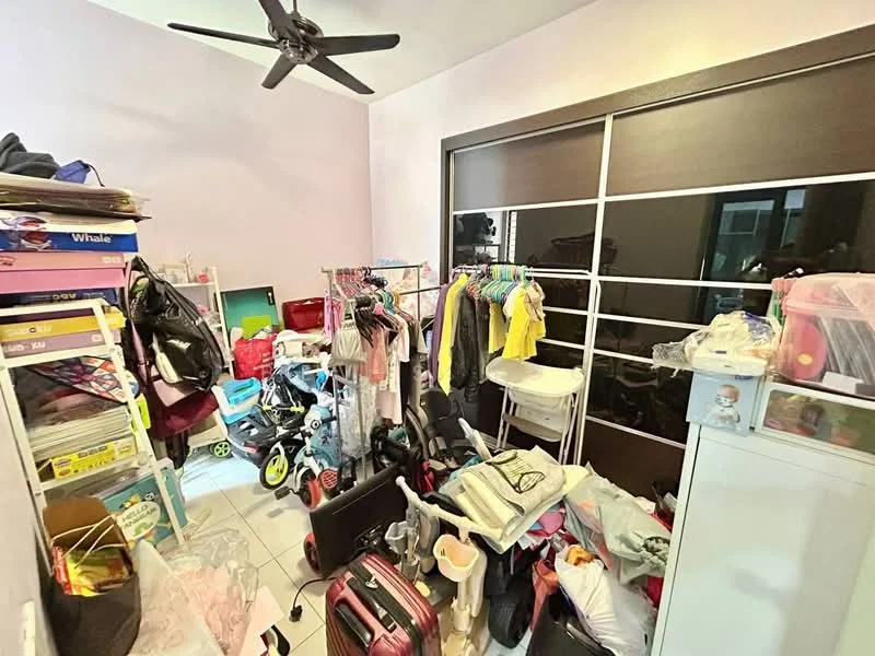 Room features: white painted walls, ceiling fan, sliding glass door wardrobe, tile flooring, cluttered with various items, clothes hanging on rack, toys and children's items, luggage, storage boxes.