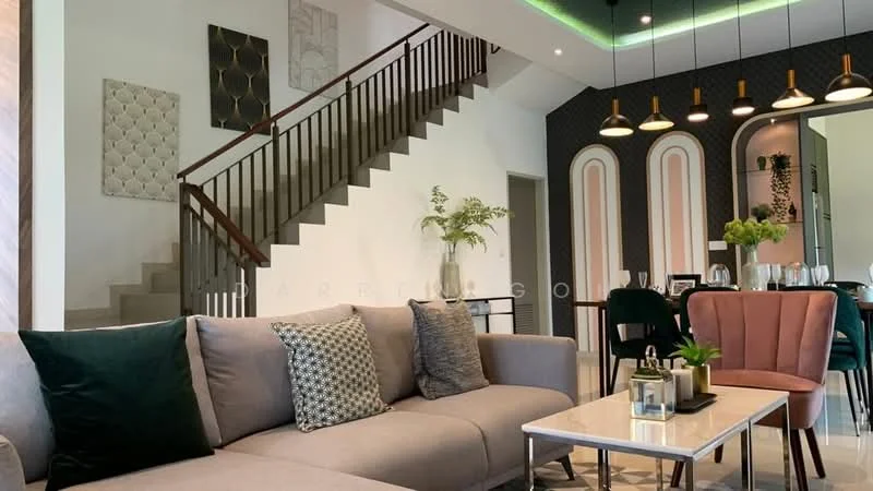Living features: 3-seater fabric sofa in grey, upholstered pink armchair, marble coffee table, decorative wall art, green accent cushions, recessed LED downlights, pendant lighting with multiple bulbs, staircase with wooden railing, wall with patterned wallpaper, dining area visible in background, greenery in decorative vase; style: modern.