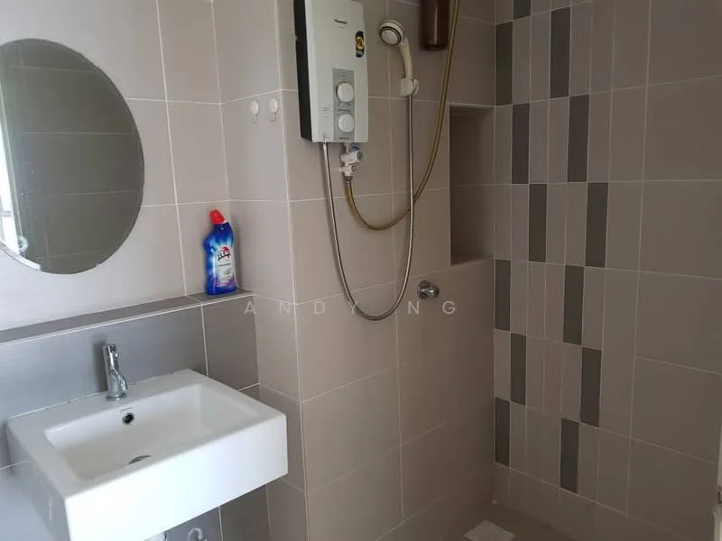 Bathroom features: white wall-mounted sink, chrome basin mixer faucet, round mirror, shower area with wall-mounted showerhead, tile cladding with grey and beige patterns, water heater unit, white tiled flooring, soap dispenser, cleaning product bottle; style: modern.