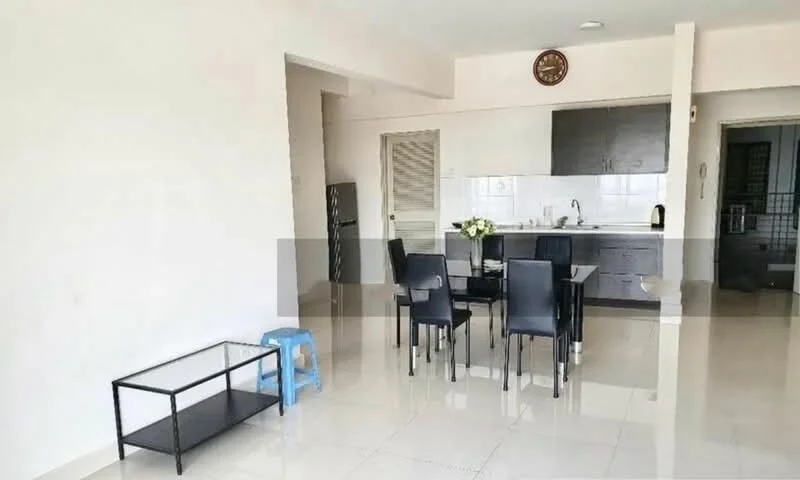 Dining features: 4-seater dining table, black dining chairs, white walls, glossy tile flooring, kitchen area visible, stainless-steel fridge, kitchen cabinets in dark wood, countertop with sink, wall clock, open layout; style: modern.