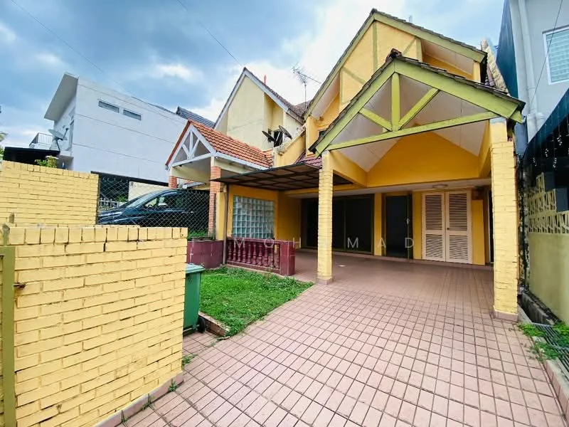 Exterior type: semi-detached house; features: yellow painted facade, pitched roof, covered car porch, brick paving, manicured lawn, fenced perimeter, outdoor lighting, two-storey structure, balcony on upper level, gutter system, exposed beams at porch, window shutters; style: traditional.