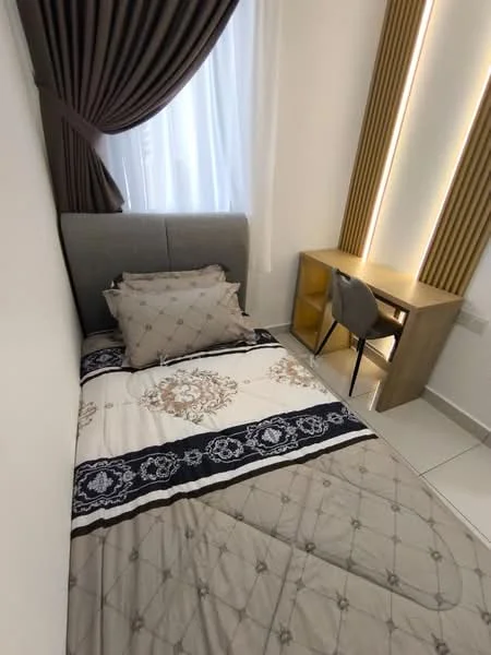 Bedroom features: single bed with grey upholstered headboard, decorative pillows, bedspread with floral pattern, white walls, curtains with dark brown color, floor-to-ceiling window, study desk in light wood, grey upholstered chair, tile flooring, LED strip lighting on wall; style: modern.
