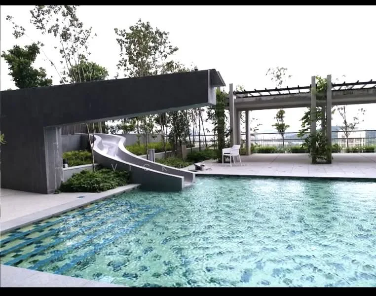 Exterior type: swimming pool deck; features: infinity pool, water slide, surrounding greenery, stone-paved deck, lounge chairs, pergola, landscaped garden, city skyline view; style: modern.