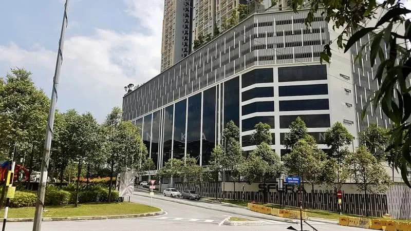 Exterior type: high-rise condominium; features: glass curtain wall, concrete facade, multiple storeys, landscaped greenery, surrounded by trees, parking area visible, modern architectural design; style: modern.