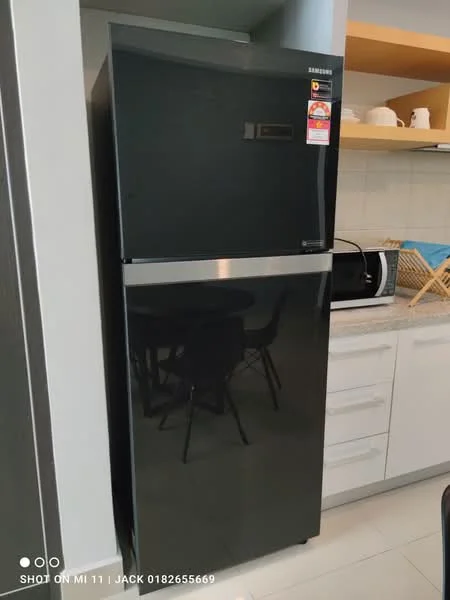 Kitchen features: black fridge, microwave, white cabinetry, grey countertop, black dining table, black dining chairs, tile backsplash, light-colored flooring; style: modern.