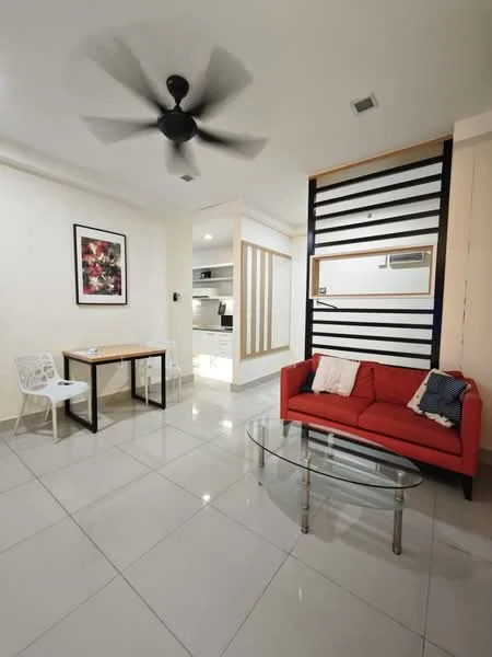Living features: red fabric sofa, glass coffee table, wooden dining table with black legs, 4 white plastic chairs, ceiling fan with 5 blades, white painted walls, tile flooring, wall-mounted shelving unit, decorative artwork on wall, mirror on wall; style: modern.