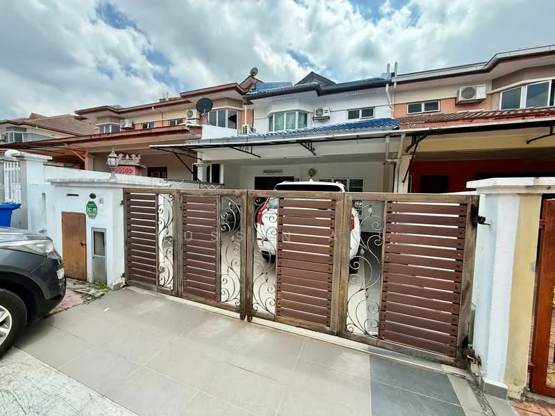 Exterior type: linked terrace house; features: brown wooden gate with decorative metalwork, paved driveway, two-storey building, multiple air conditioning units visible, front porch area, white painted facade, red accent wall, roof overhang, manicured landscaping, visible neighboring houses; style: modern.