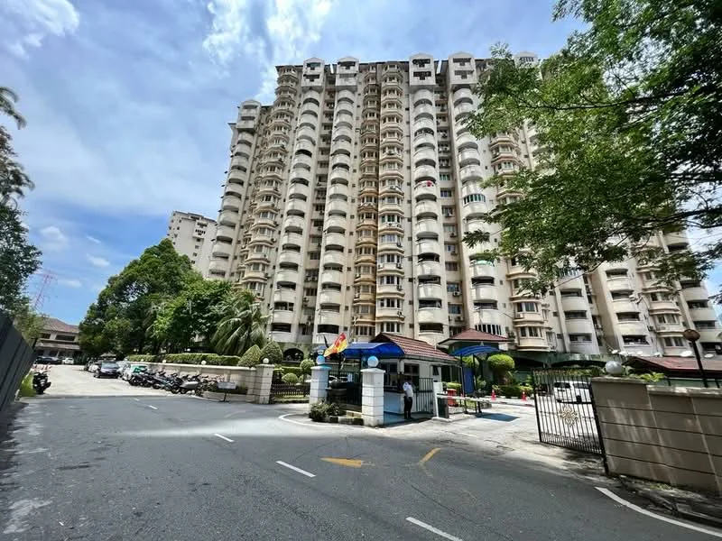 Exterior type: high-rise condominium; features: white painted facade, recessed balconies, multiple storeys, landscaped garden, guard house at entrance, paved driveway, surrounded by mature greenery, swimming pool visible, parking area, security gate; style: modern.