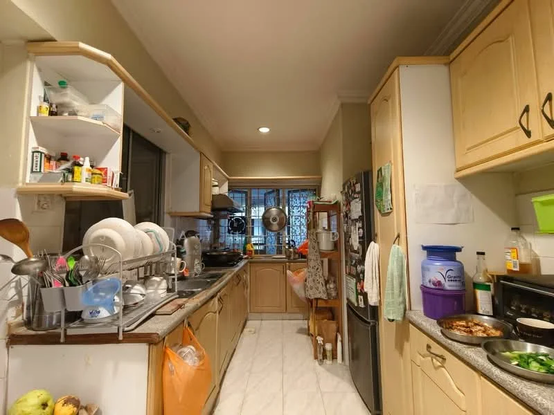 Kitchen features: cream cabinetry with wooden handles, grey granite countertop, stainless-steel sink, chrome pull-down faucet, built-in oven, freestanding refrigerator, microwave, dish rack with dishes, open shelving, tile flooring, window with light filtering, kitchen island, various kitchen appliances, hanging pot rack, wall-mounted spice rack; style: traditional.