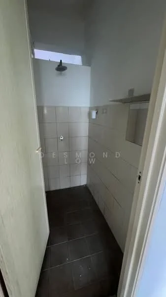 Bathroom features: shower area with overhead shower head, white tiled walls, dark tiled flooring, small shelf above shower, toilet flush button, window for natural light, door for privacy.