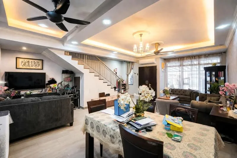 Living features: 5-blade ceiling fan with light, chandelier, sofa in dark grey, armchair in beige, coffee table, TV console, wall-mounted TV, decorative wall art, curtains, area rug, staircase with wooden railing, light-coloured walls with crown moulding, laminate flooring, potted plants; style: modern. Dining features: 6-seater dining table, wooden dining chairs, tablecloth, decorative flowers, open shelving, kitchen area visible in background; style: modern.