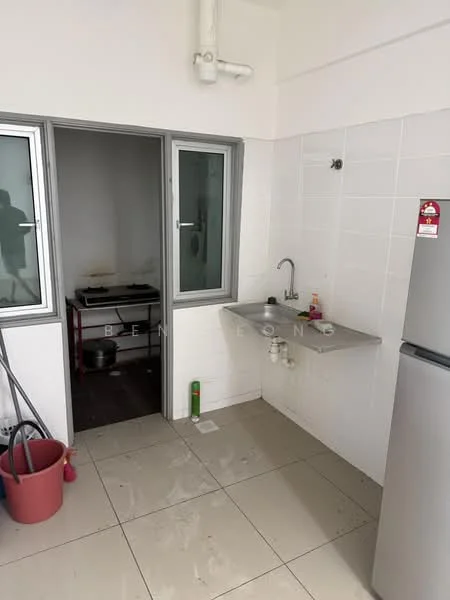 Kitchen features: stainless-steel sink, chrome faucet, grey countertop, white tiled walls, ceramic tile flooring, built-in cabinets, freestanding gas stove, refrigerator, window with glass panes, cleaning supplies, bucket, wall-mounted pipe, open layout; style: modern. Room features: white tiled walls, ceramic tile flooring, doorway to another room.