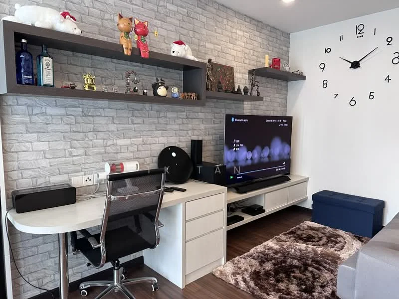 Living features: grey stone accent wall, white painted walls, wood laminate flooring, 3-seater fabric sofa in grey, coffee table, wall-mounted TV, TV console with storage, decorative shelf with figurines, area rug with geometric pattern, desk with ergonomic chair, wall clock, decorative items on shelf; style: modern.