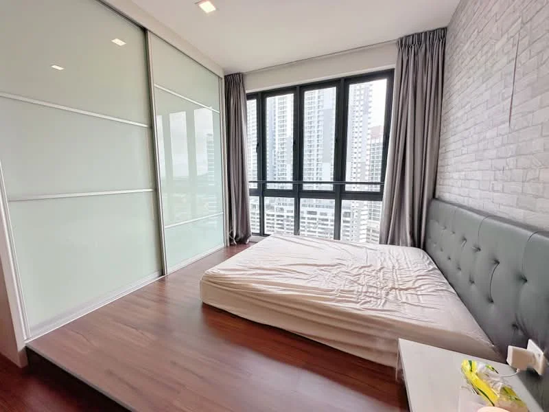 Bedroom features: queen-size bed, upholstered headboard, floor-to-ceiling windows, grey curtains, wooden flooring, exposed brick accent wall, built-in wardrobe with sliding doors, nightstand, decorative plant; style: modern; view: city.