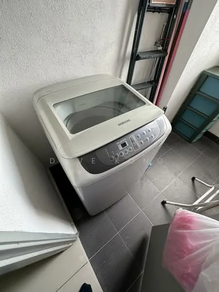 Laundry features: top-load washing machine, grey exterior, transparent lid, control panel with buttons, black tiled flooring, white painted walls, laundry basket, metal drying rack.