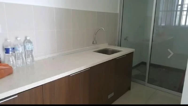 Kitchen features: single-bowl stainless-steel sink, chrome pull-down faucet, white quartz countertop, brown wooden cabinetry, tile backsplash, glass sliding door, water bottles on countertop, neutral tile flooring; style: modern.