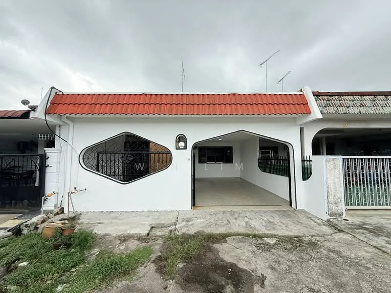 Exterior type: linked terrace house; features: white painted facade, red pitched tile roof, unique window shape, open car porch, concrete driveway, fenced front yard, manicured grass area, satellite dish visible, two-storey adjacent house; style: modern.