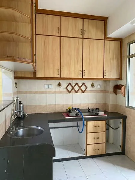 Kitchen features: single-bowl stainless-steel sink, black granite countertop, wooden cabinetry with light wood finish, gas stove with two burners, white tiled backsplash, cream tiled walls, grey tiled flooring, under-sink storage cabinet, window with natural light; style: modern.