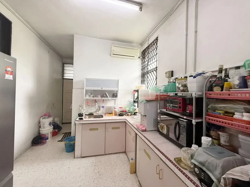 Kitchen features: white painted walls, tile flooring, wall-mounted split AC, kitchen cabinets with pink finish, countertop with tiled edge, microwave, stainless-steel fridge, sink, various kitchen utensils and containers, open shelving, window with security bars, light fixture on ceiling.