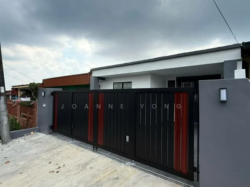 Exterior features: black and red metal gate, concrete driveway, grey painted walls, modern exterior lighting, surrounding fence, asphalt road, cloudy sky; style: modern.