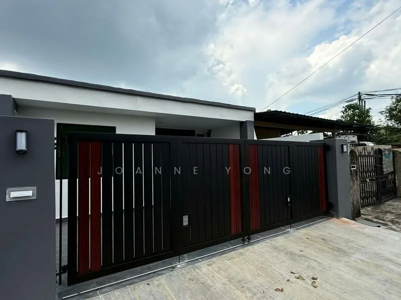 Exterior features: black metal gate with red accents, concrete driveway, white painted facade, flat roof, surrounded by fencing, clear sky, single-storey structure; style: modern.