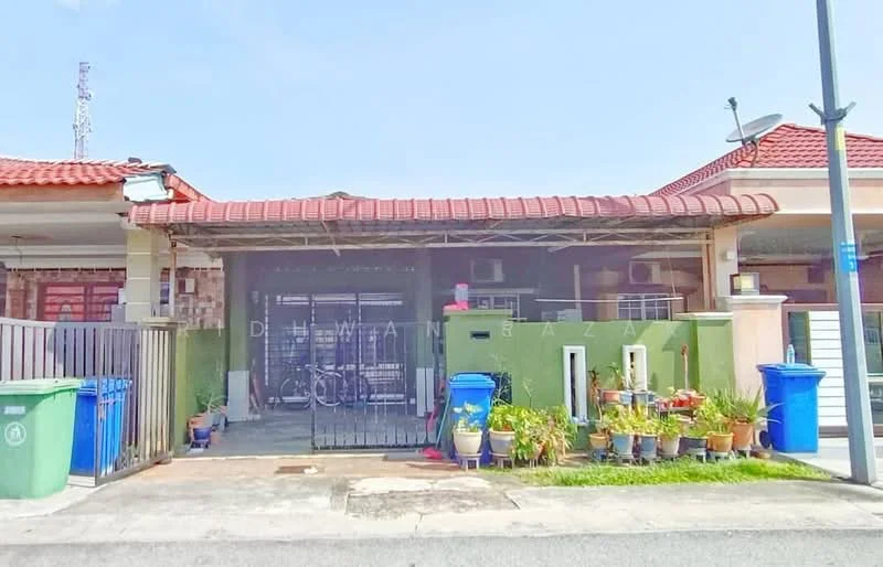 Exterior type: linked terrace house; features: red tiled roof, cream painted facade, green accent wall, front porch with awning, manicured garden with potted plants, bicycle visible in front, metal gate, two green waste bins, air conditioning units visible, security grill at entrance; style: modern.