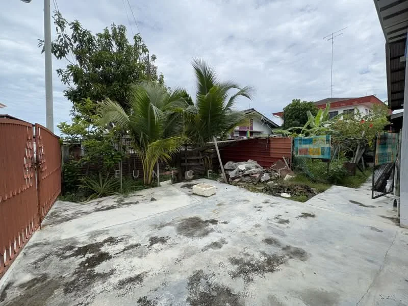 Exterior features: concrete flooring, palm trees, manicured lawn, fenced yard, garden area, landscaped greenery, paved walkway, surrounding residential buildings.