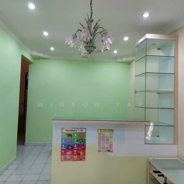 Room features: green painted walls, white ceiling, recessed downlights, chandelier with floral design, tiled flooring, glass display cabinet, open counter, colorful educational wall chart; style: modern.
