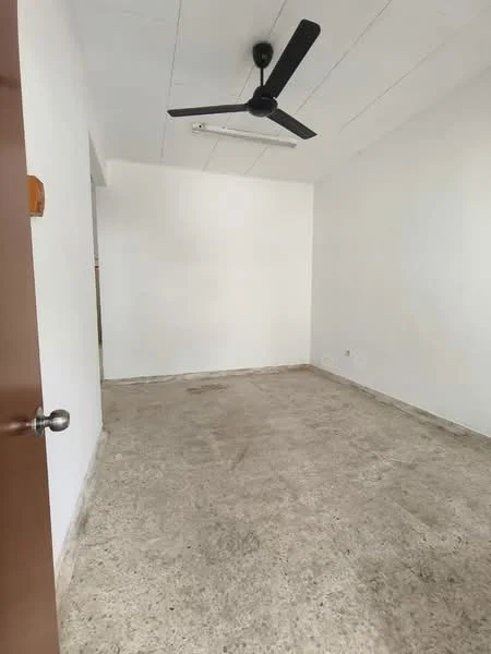 Room features: white painted walls, concrete flooring, 5-blade ceiling fan, no visible windows, no visible furniture, plain ceiling, single door entrance; style: minimalist.