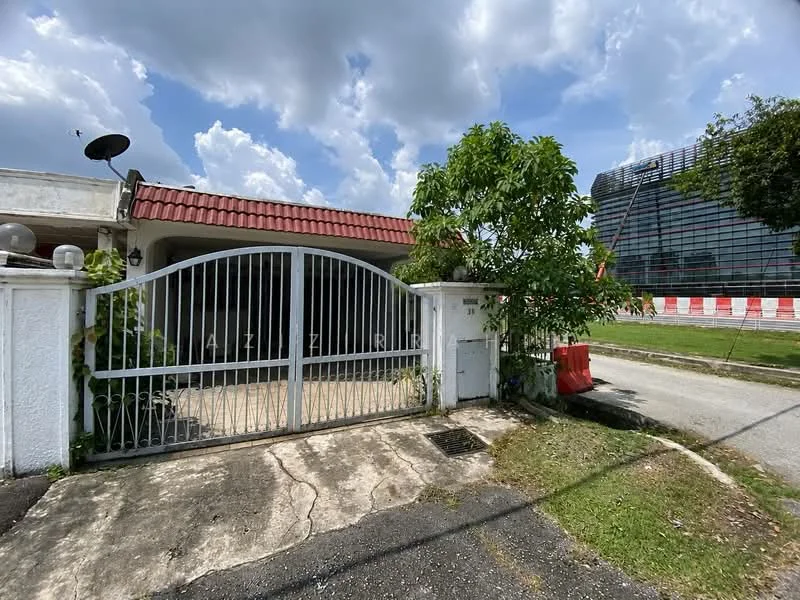 Exterior type: detached bungalow; features: white painted facade, red tiled roof, metal gate, concrete driveway, landscaped garden with small tree, surrounding greenery, adjacent to modern building, paved walkway; style: traditional.
