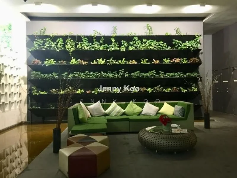 Living features: green fabric sofa, decorative cushions in various colors, round coffee table with intricate design, geometric patterned ottoman, vertical garden wall with greenery, polished concrete flooring, recessed ceiling lights, decorative branches in vases; style: modern.
