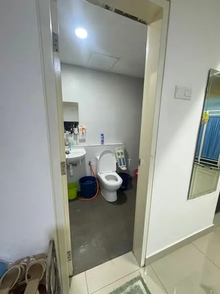 Bathroom features: white toilet, single-sink vanity with mirror, grey wall tiles, ceramic floor tiles, recessed lighting, shower area, toilet paper holder, cleaning supplies storage, colorful cleaning buckets; style: modern.