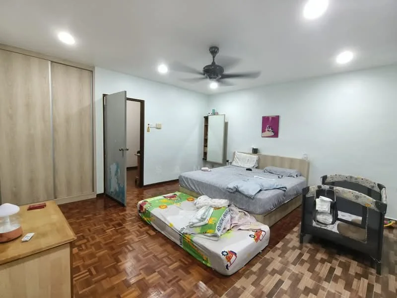 Bedroom features: wooden flooring, light blue painted walls, 5-blade ceiling fan with light, queen-size bed with grey bedding, mattress on the floor, built-in wardrobe with wooden doors, mirror on the wall, decorative artwork on the wall, nightstand with lamp, baby crib, open door, window with no visible treatment; style: modern.