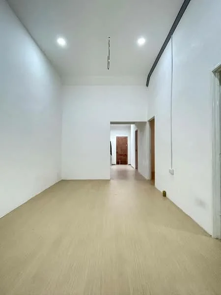 Room features: white painted walls, light-colored flooring, recessed LED downlights, doorway leading to another room, doorway leading to hallway, no visible furniture or decor; style: minimalist.
