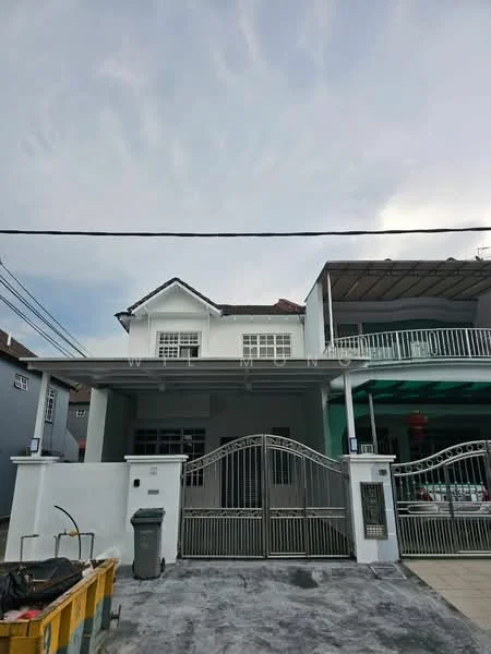 Exterior type: linked terrace house; features: white painted facade, gabled roof, two-storey structure, metal gate, paved driveway, front porch, balcony on upper floor, visible utility bin, surrounding residential area; style: modern.