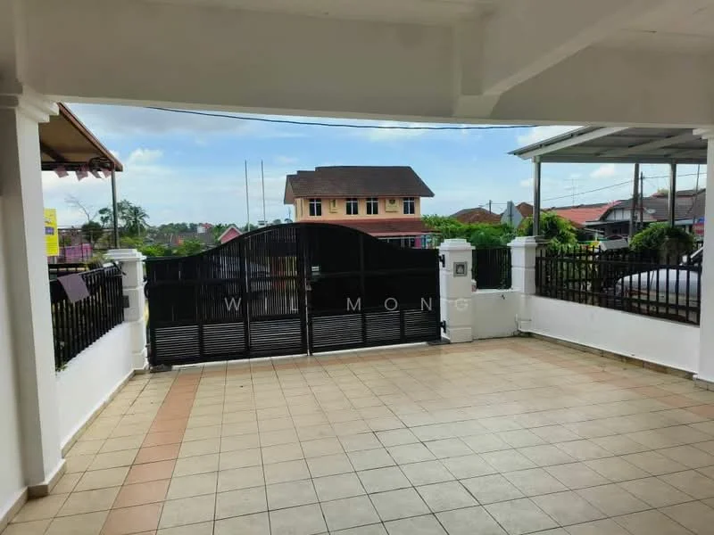 Exterior features: paved flooring, black metal gate, white painted walls, surrounding greenery, two-storey building in background, clear blue sky, fenced perimeter; style: modern.