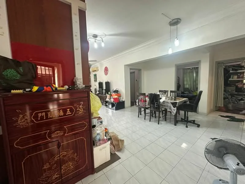 Dining features: white tiled flooring, dining table with black chairs, wooden cabinet with decorative carvings, ceiling lights, open layout to living area, wall-mounted fan, green curtains, cluttered storage area, decorative wall art. Living features: white tiled flooring, sofa set, TV console, cluttered storage area, wall-mounted shelves, decorative items, open layout to dining area.
