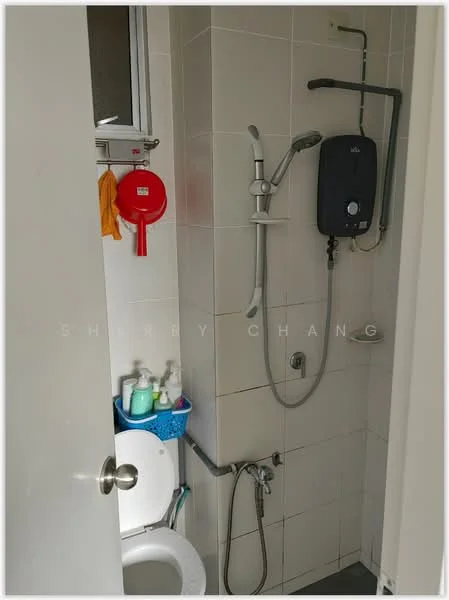 Bathroom features: white tiled walls, ceramic tile flooring, one-piece toilet, shower with handheld showerhead, wall-mounted water heater, shower hose, soap dispenser, toiletries storage basket, towel rack, mirror above sink.