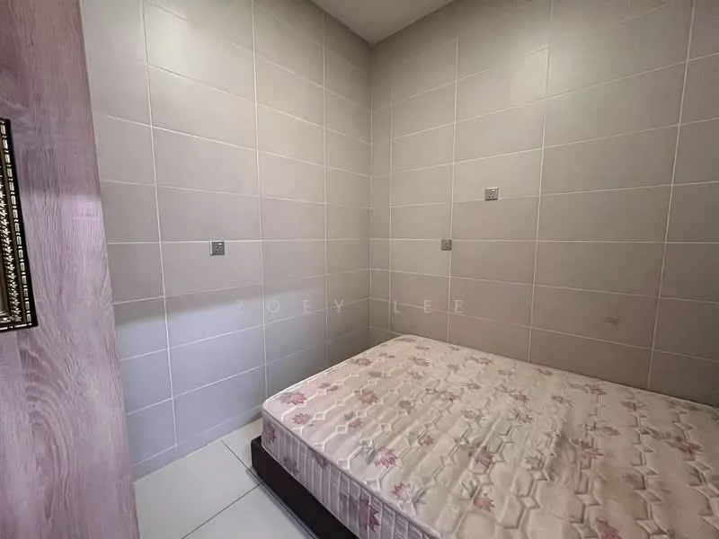 Room features: light grey tiled walls, white tiled flooring, single bed mattress, no visible headboard, corner room layout, minimal decor, electrical outlets on walls, no visible windows; style: minimalist.