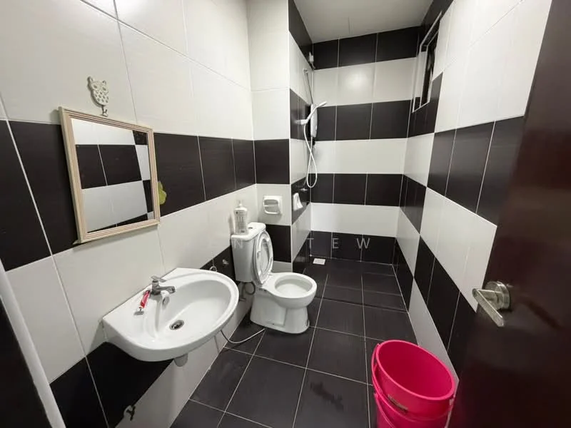 Bathroom features: black and white tiled walls, black floor tiles, single-bowl sink, chrome faucet, framed mirror, one-piece toilet, shower with wall-mounted showerhead, toilet paper holder, pink bucket; style: modern.