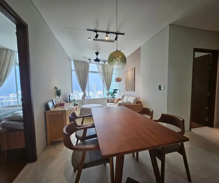 Dining features: wooden dining table, 4 wooden dining chairs, pendant light fixture, floor-to-ceiling windows, city skyline view, light-colored walls, neutral flooring, decorative wall art; style: modern; view: city. Living features: fabric sofa, coffee table, floor-to-ceiling windows, light-colored walls, neutral flooring, decorative plants; style: modern; view: city.