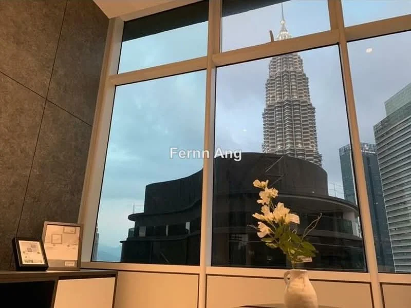 Room features: floor-to-ceiling windows, city skyline view, decorative vase with flowers, dark wood furniture, grey accent wall, framed artwork, minimalist decor; style: modern; view: city.