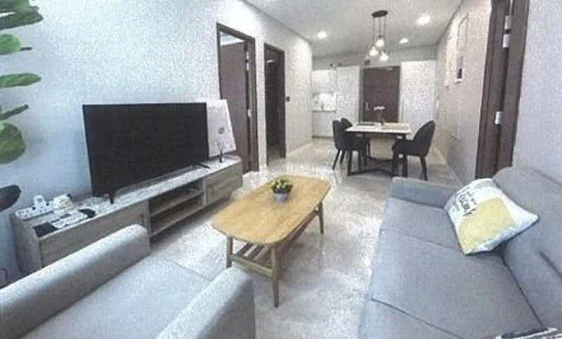 Living features: light grey fabric sofa, 2-seater sofa, wooden coffee table, TV console, wall-mounted TV, decorative plant, recessed ceiling lights, cream painted walls, marble tile flooring, dining table with chairs in background; style: modern.