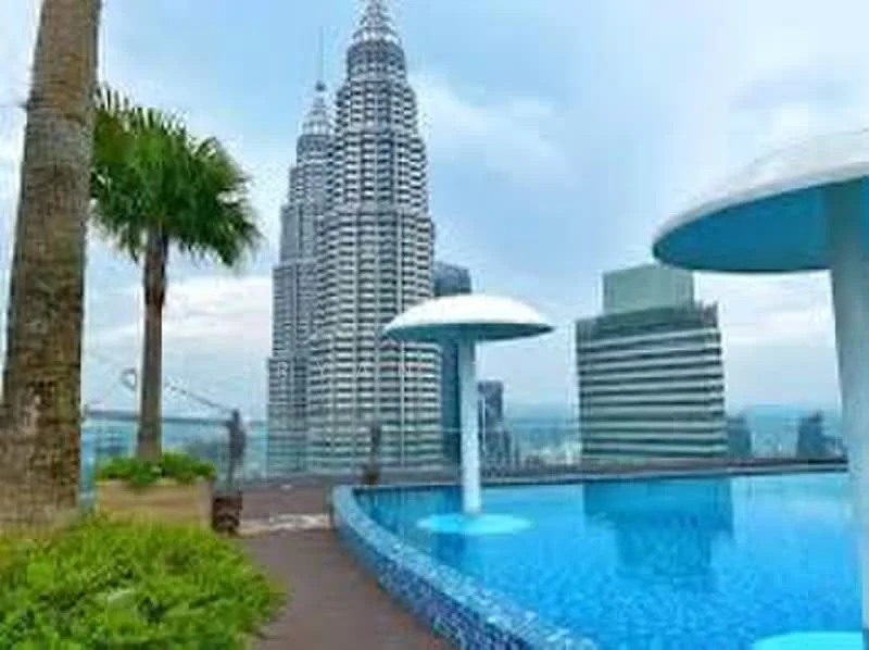 Exterior type: swimming pool deck; features: infinity pool, pool deck with loungers, landscaped garden with palm trees, city skyline view, surrounded by high-rise buildings, decorative water features; style: modern.